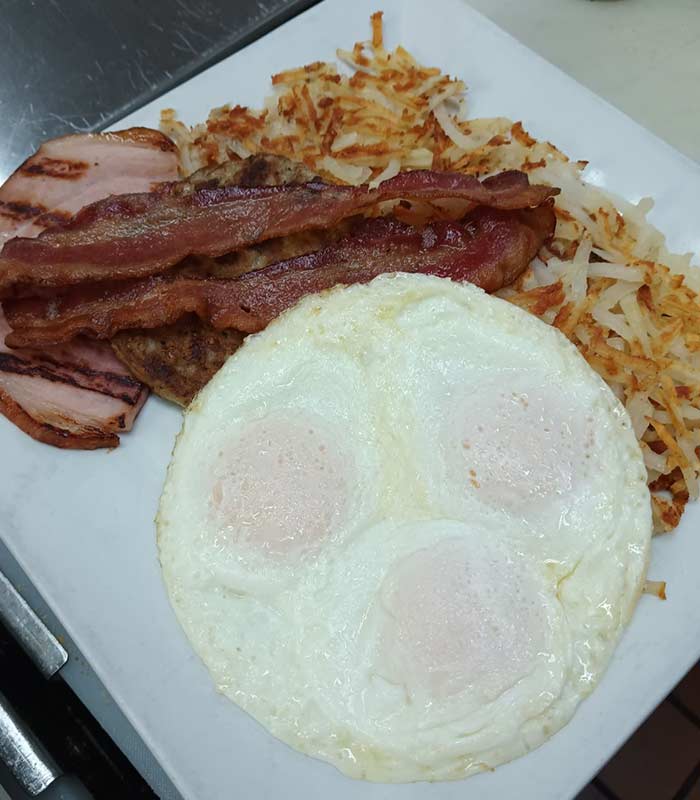 The belly buster with. ham, bacon, eggs and hashbrows for breakfast from Omar's Hi-Way Chef in Tuscan AZ