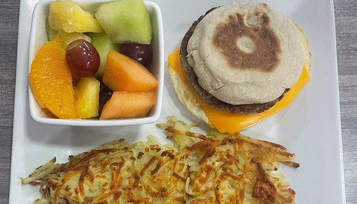 Omars at TTT is serving monday special of an english muffin breakfast sandwich with fruit and hashbrowns.