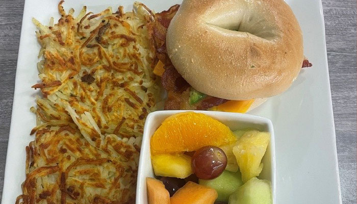 Tuesday special at Omars at the TTT, bagel breakfast sandwich with fruit and hashbrowns.