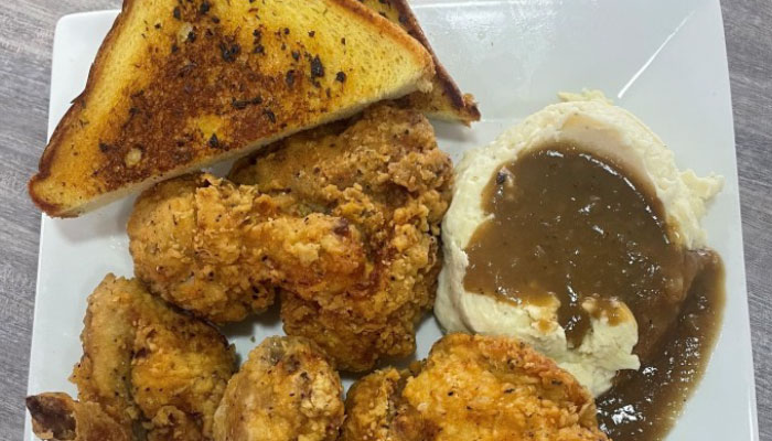 Omars at the TTT Tuesday special fried chicken plate with mashed potatoes and toast.